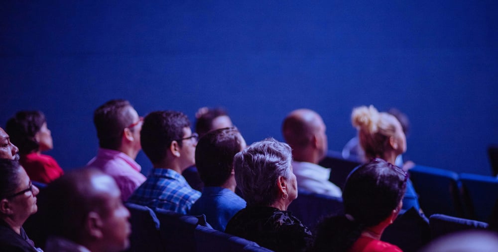 Personer i biosalong tittar på film